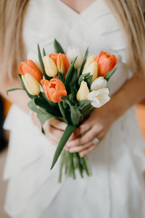 detail svatební kytice z tulipánů v rukou nevěsty