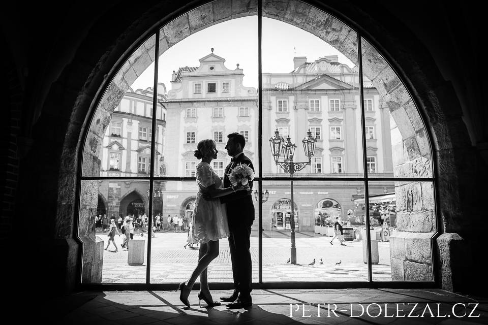 Black&white photo of bride and groom in front of big window