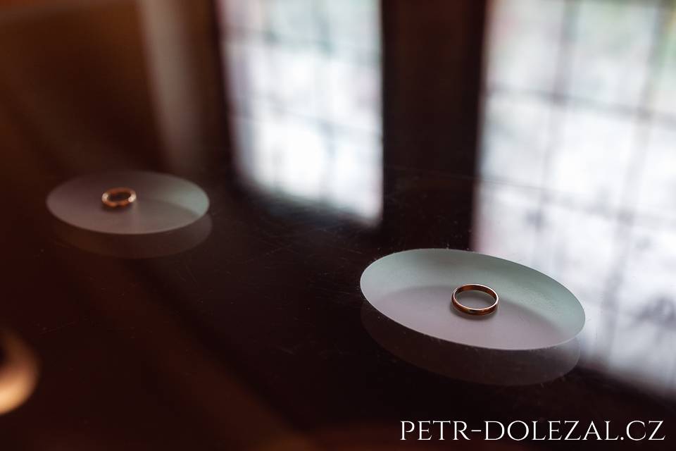 detail of wedding rings on glass table