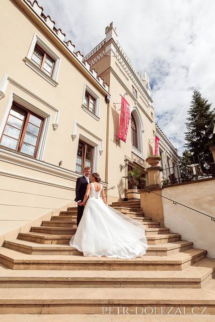 Bride and groom on stairs leading to Chateau St Havel