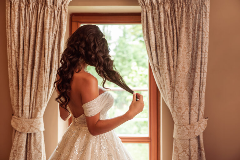Bride in front of a window - original wedding photographer