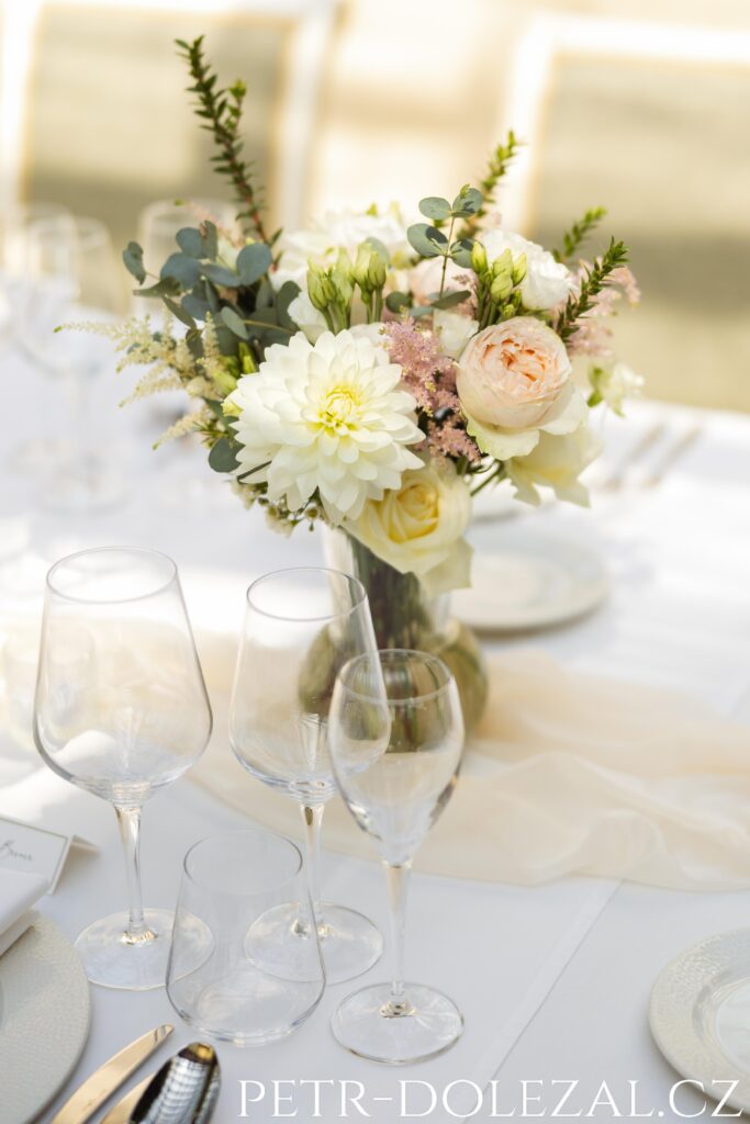 Detail květinové výzdoby stolu pro svatební hostinu